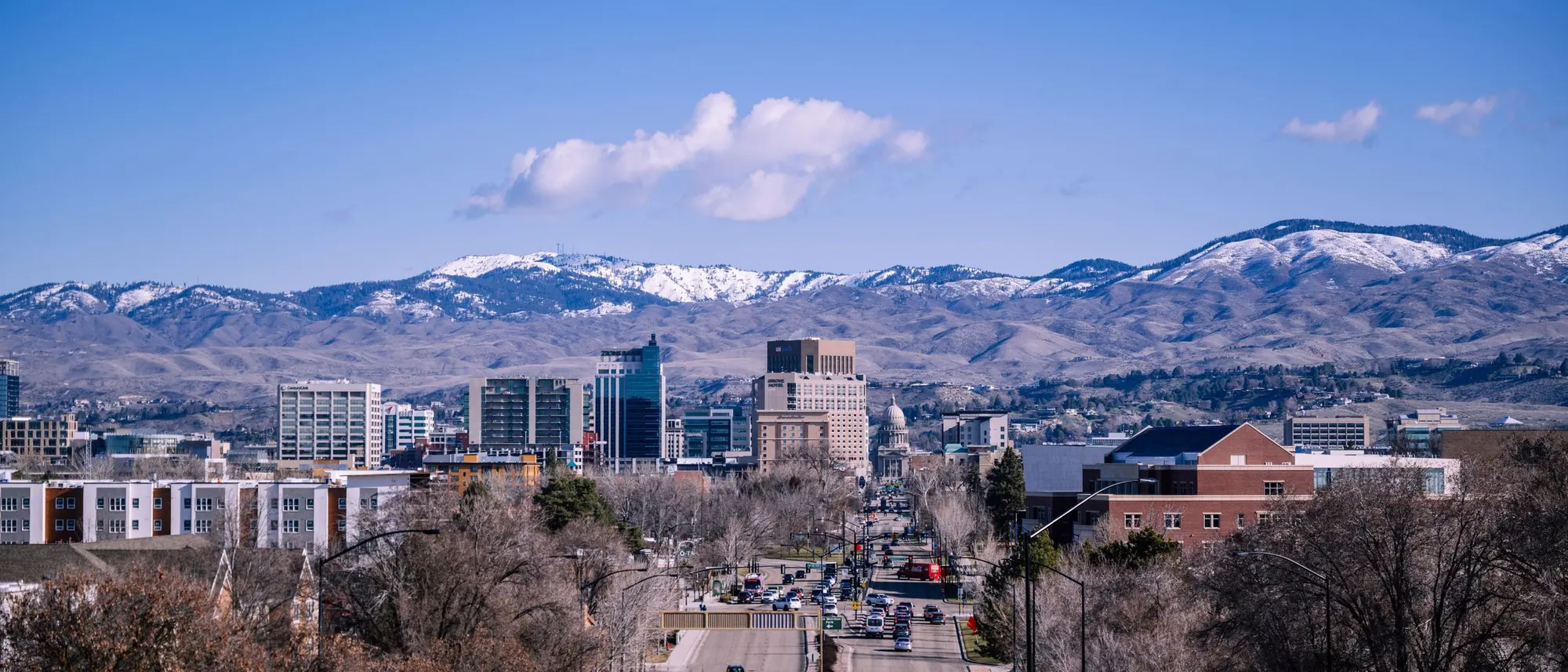Stock photo of downtown Boise with the snow-capped foothills behind it